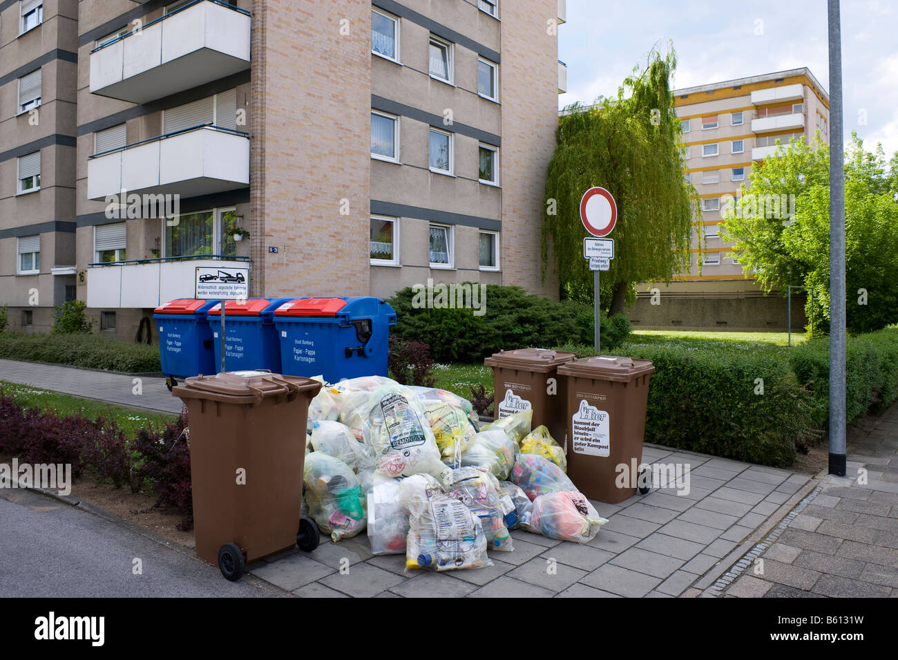 Recycling in Germany, yellow bags and waste paper in front of apartment