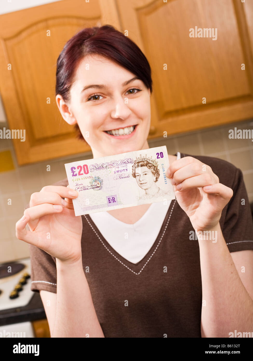Young woman holding a 20 note - MR PR Stock Photo
