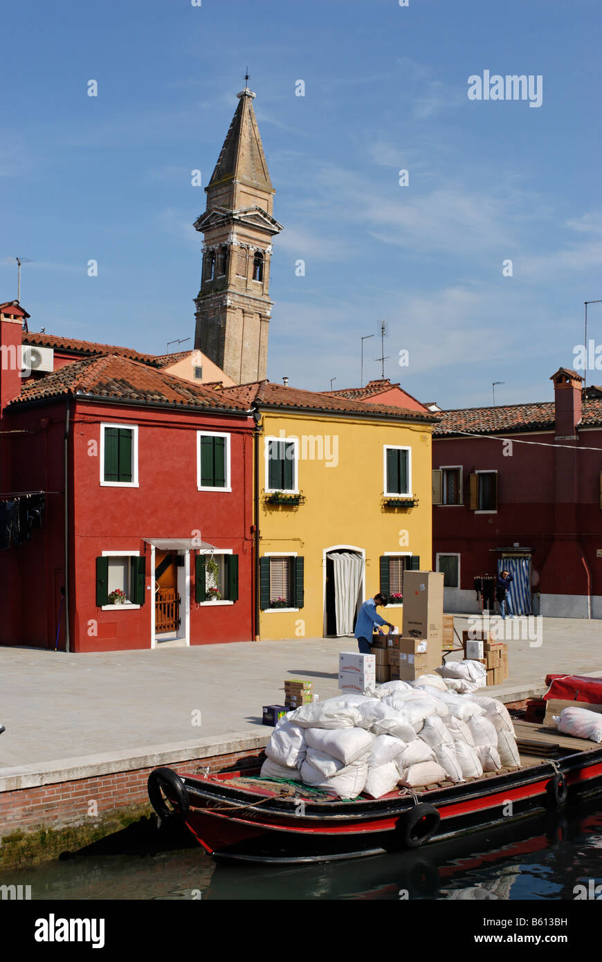 Colourfully painted houses and the leaning tower of the Church of St. Martino at a canal on Burano Stock Photo