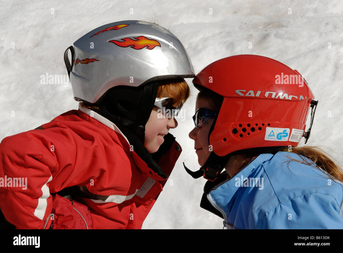 Two children wearing helmets for skiing Stock Photo Alamy