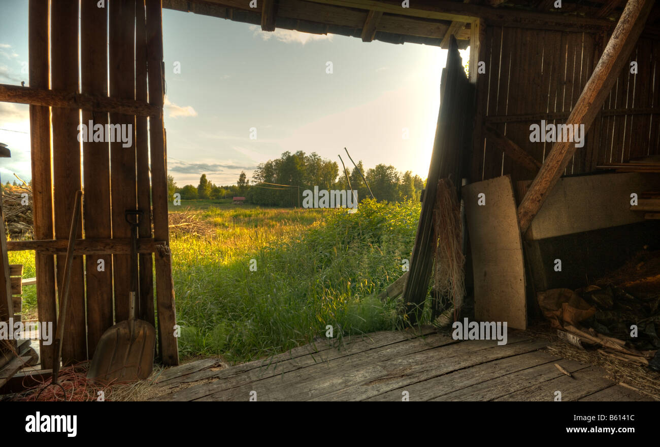 Summer landscape through barn door Stock Photo