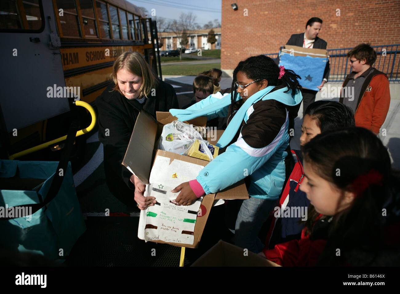Teachers, volunteers and School Children collecting food for charity. Helping the needy, Stock Photo