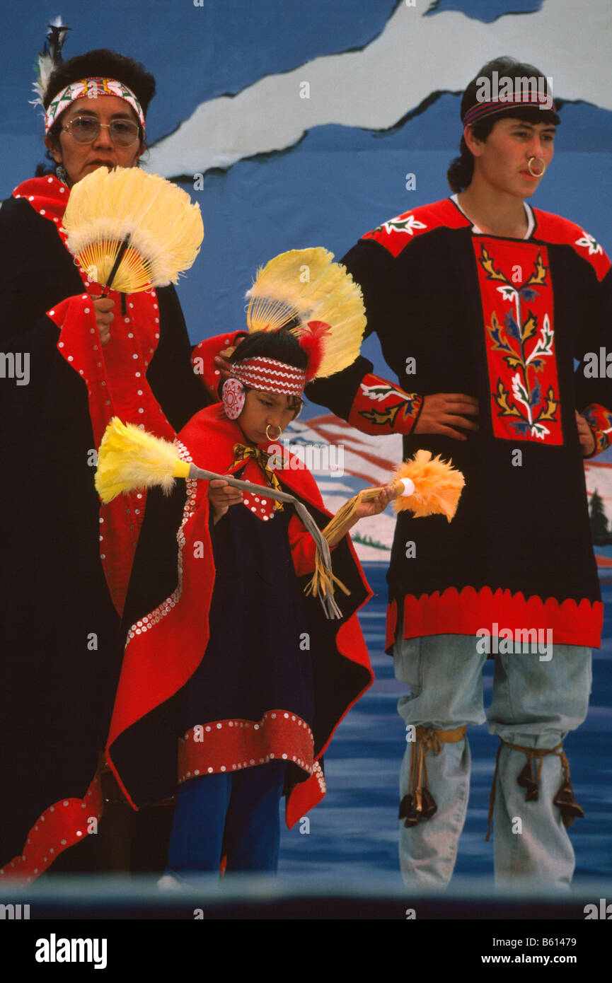Native American Tlingit Indian Family celebrating at a Pow Wow in Traditional Ceremonial Regalia Dress Stock Photo
