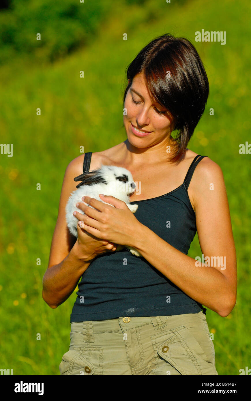 Young woman carrying a Pygmy Rabbit (Brachylagus idahoensis) Stock Photo