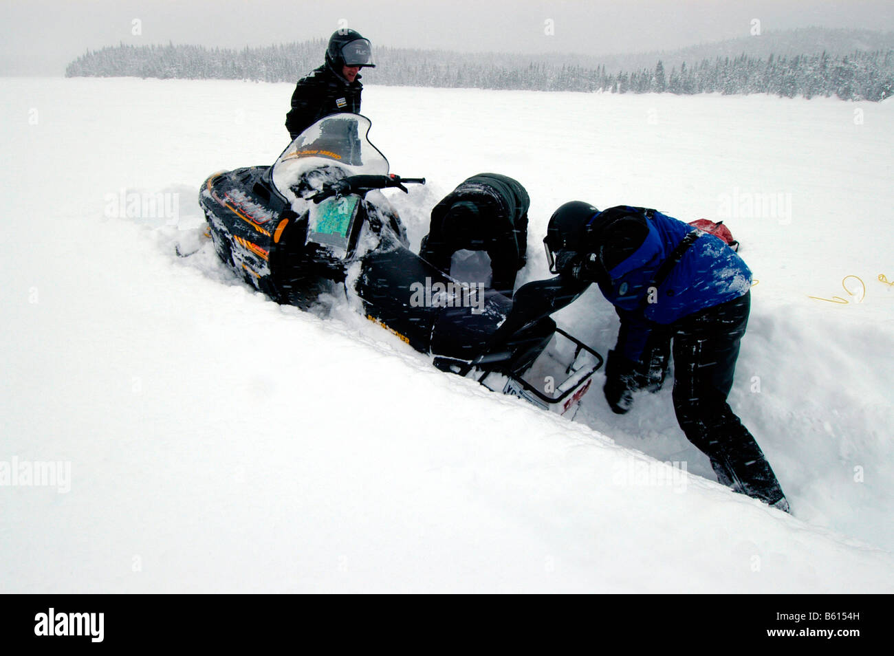 Snowmobile stuck in deep snow, Saguenay-Lac Saint Jean, Mont Valin Region, Quebec, Canada, North America Stock Photo