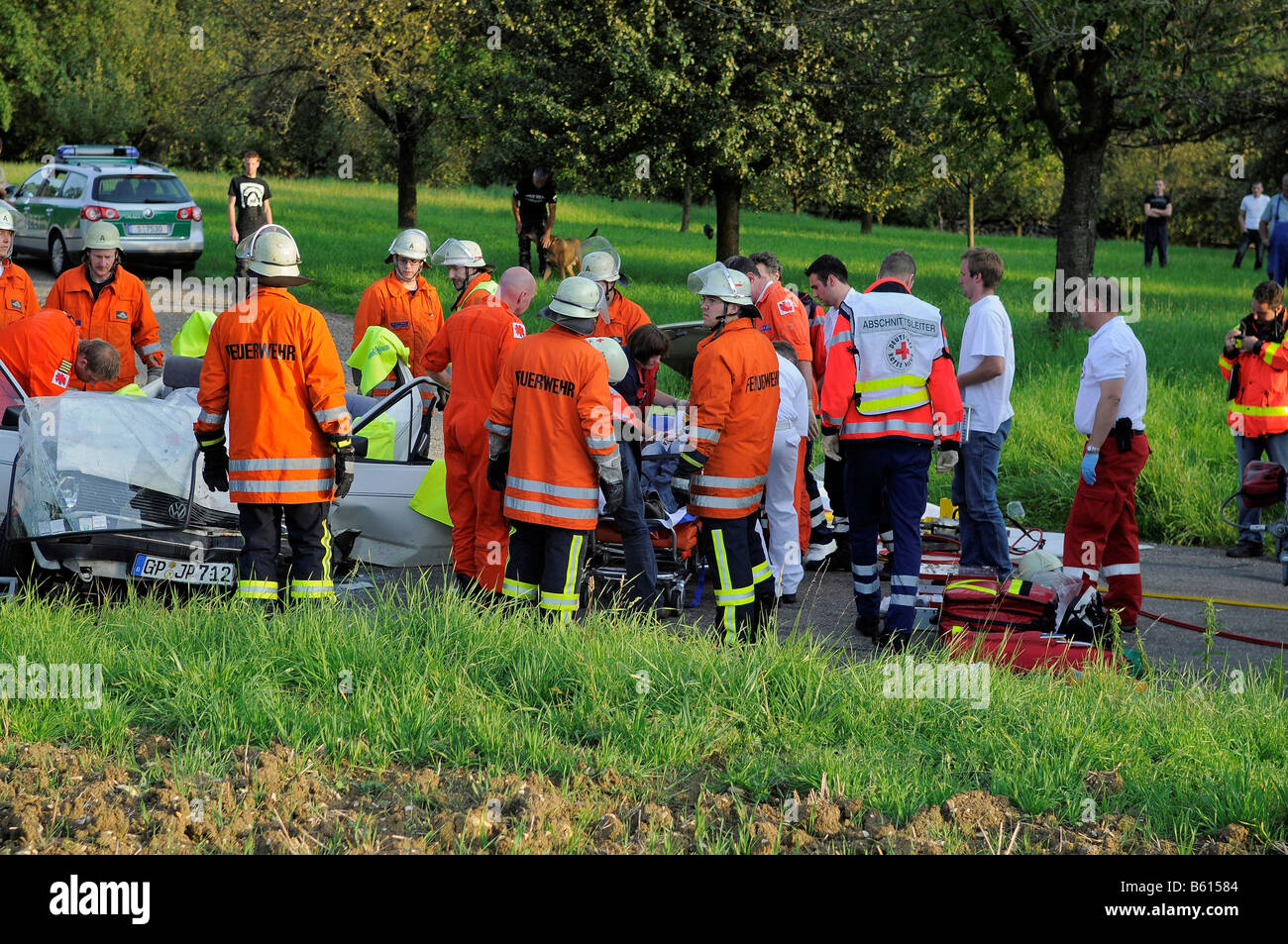 Emergency rescue service providing first-aid to an injured passenger following a severe accident on the L 1213 between Weilheim Stock Photo