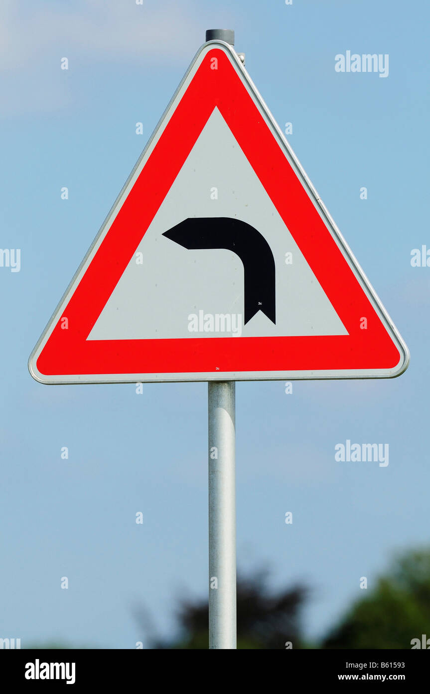 Road sign on the street edge warning about a sharp left hand curve, Aldorf, Baden-Wuerttemberg Stock Photo