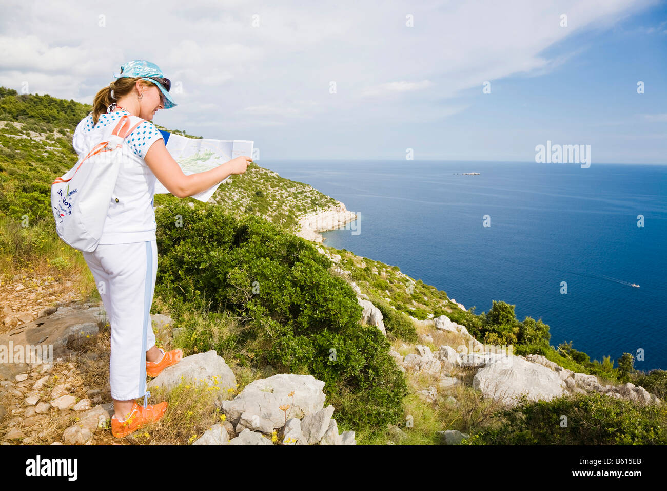 Young woman reading a map, Mljet Island, Dubrovnik-Neretva, Dalmatia, Croatia, Europe Stock Photo