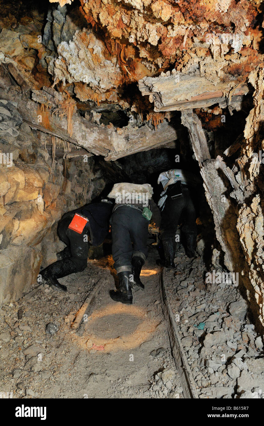 Miners pushing trolleys in a collapsed tunnel, Llallagua mining centre, Potosi, Bolivia, South America Stock Photo