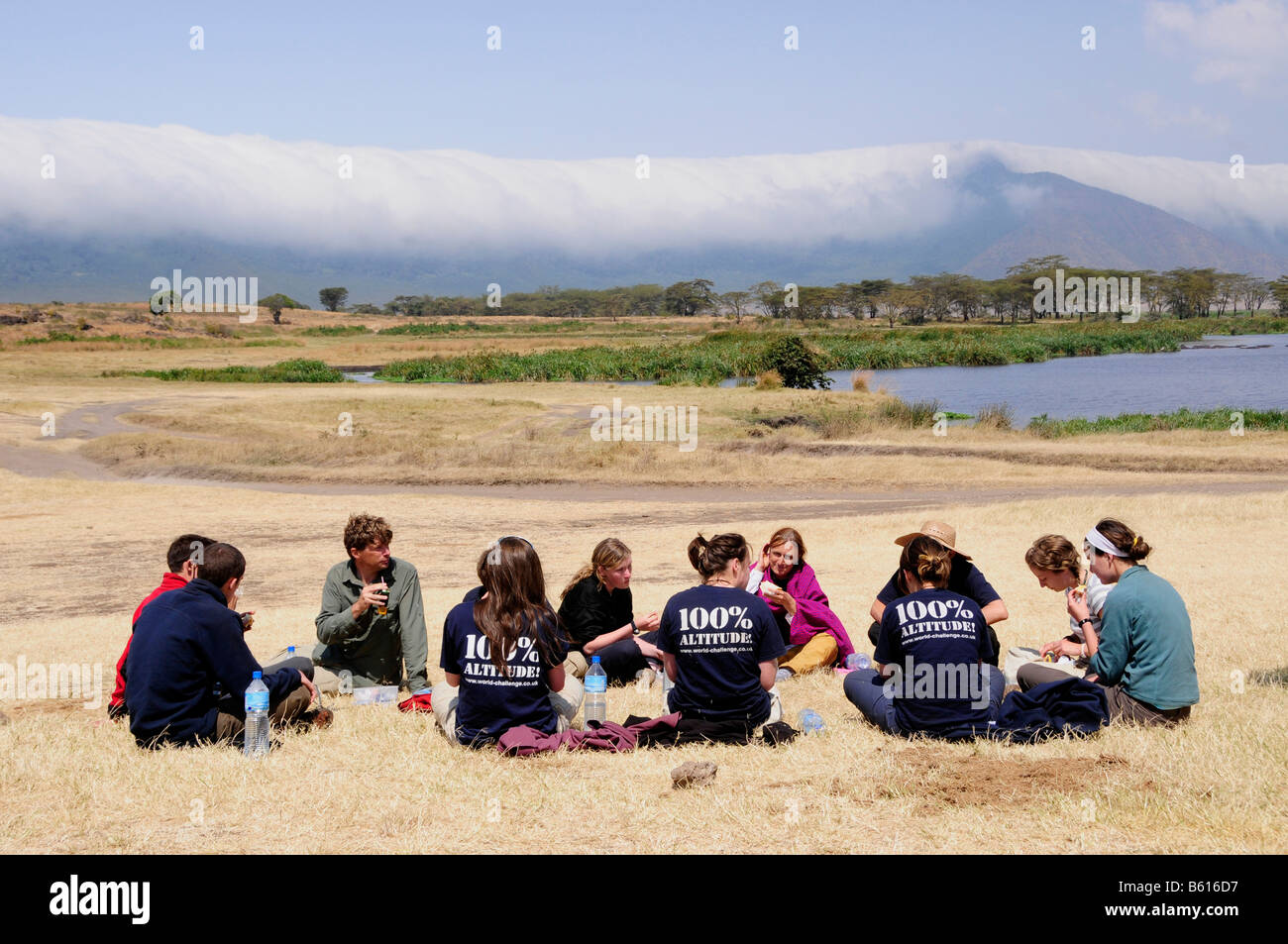 Tourists picnicing in front of the cloud covered edge of the Ngorongoro-crater, Ngorongoro Conservation Area, Tanzania, Africa Stock Photo