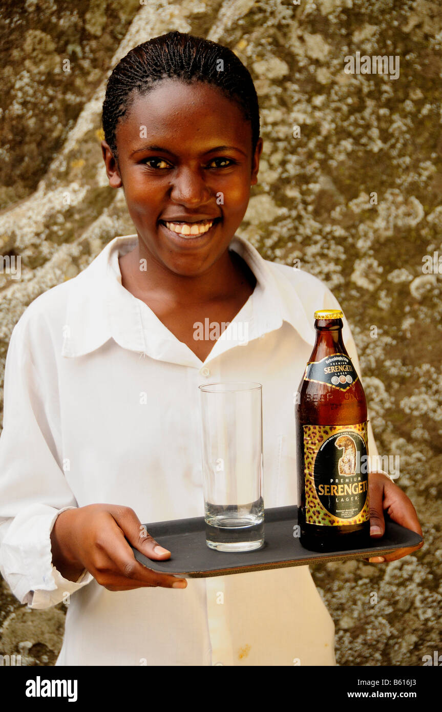 Waitress carrying the most popular beer brand in Tanzania, Serengeti