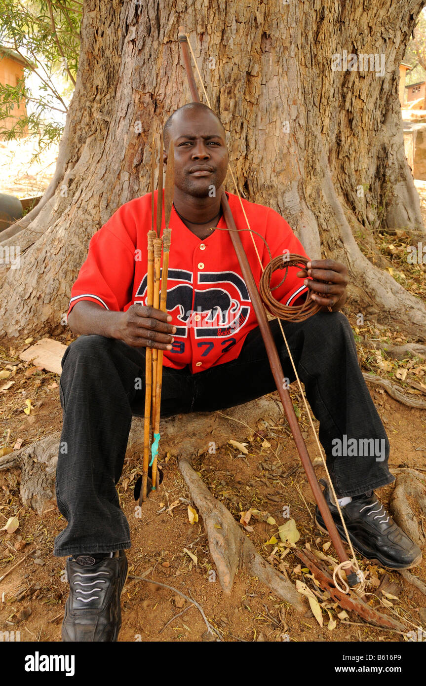 Ranger of the Kenya Wildlife Service, anti-poaching unit, with confiscated arrows, bows and slings in the Park headquarters in Stock Photo