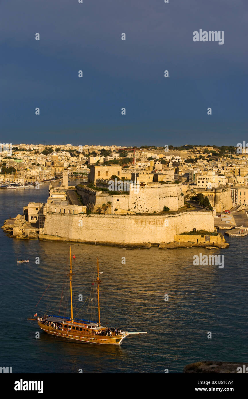 Fort San Angelo, Vittoriosa, The Three Cities from La Valletta with Grand Harbour and a twin-masted sailing ship, Malta, Europe Stock Photo