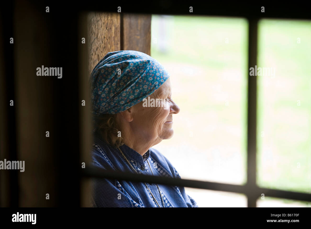 Farmer's wife looking through a window, Open Air Museum, Tallinn, Estonia, Baltic States, Northeastern Europe Stock Photo