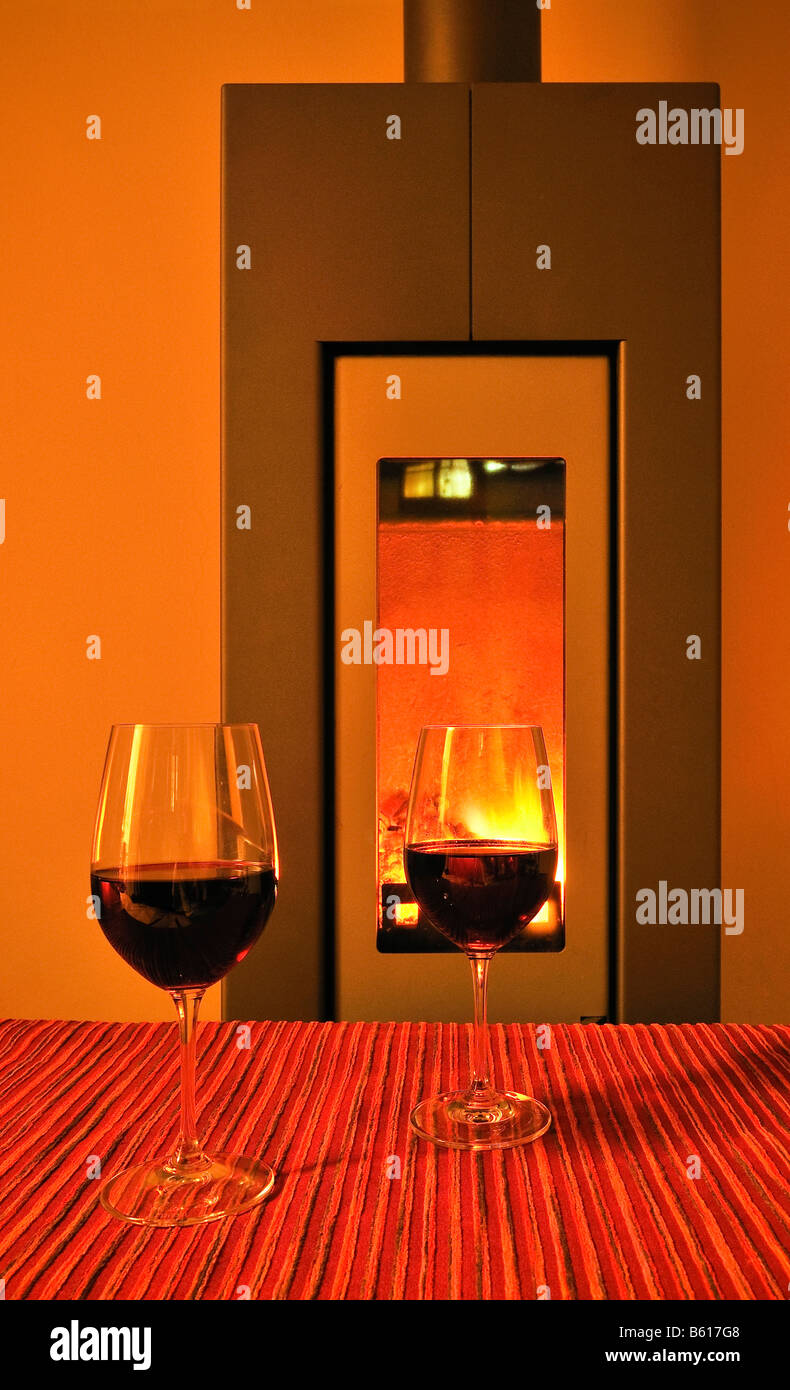 Two glasses of red wine in front of a fire in a fireplace Stock Photo Alamy