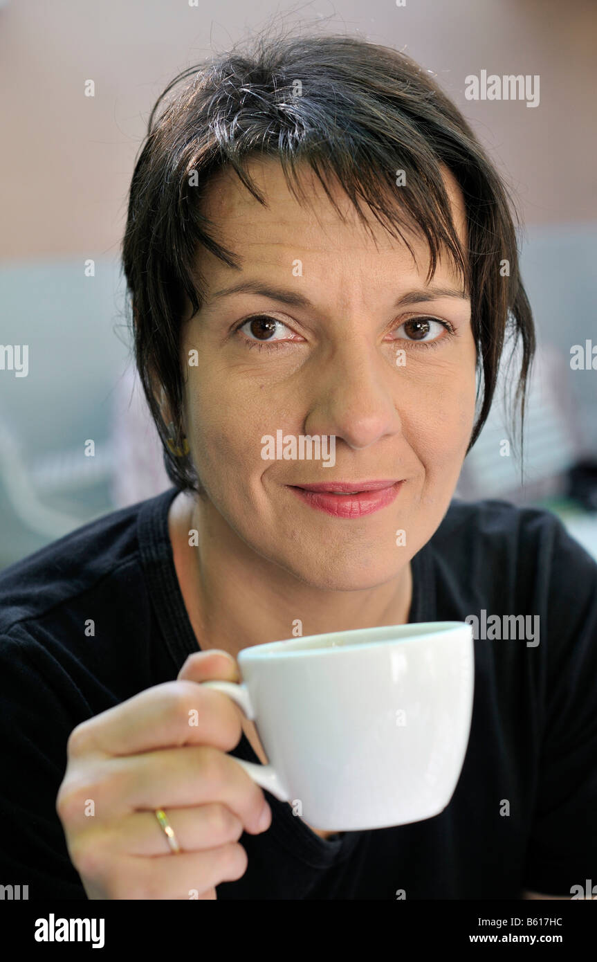 Woman holding a coffee cup Stock Photo