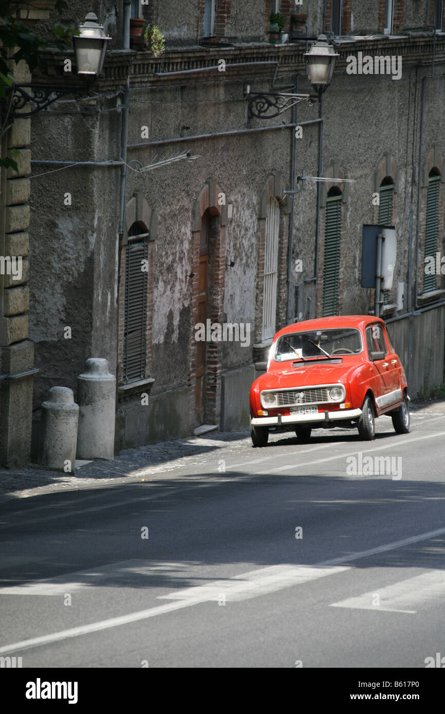 one red vintage car parked in street in italy Stock Photo - Alamy