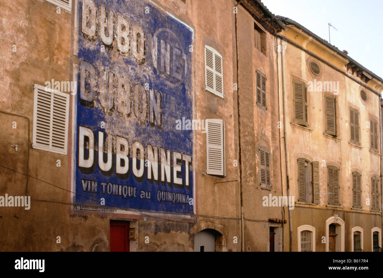 An old painted advertisement on the side of a house in the old ton of Aups Provence Southern France Stock Photo