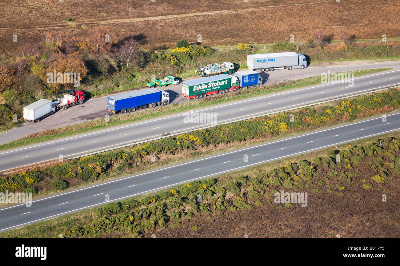 Aerial view of lorries and trucks parked in a layby. A31, New Forest. Borders of Hampshire and Dorset. UK. Stock Photo