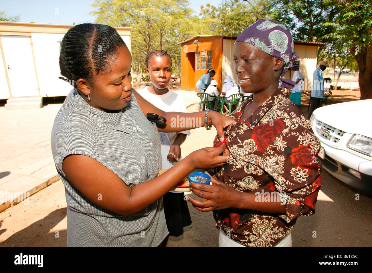 Woman wearing an AIDS ribbon, AIDS Support Group, Francistown, Botswana
