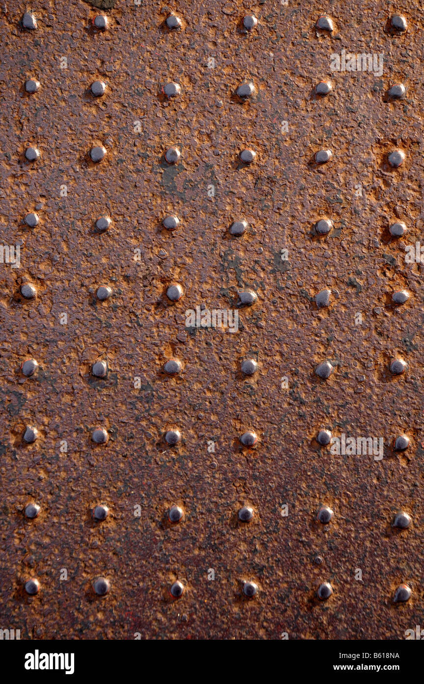 Rusted steel plate covered in rivets Stock Photo Alamy