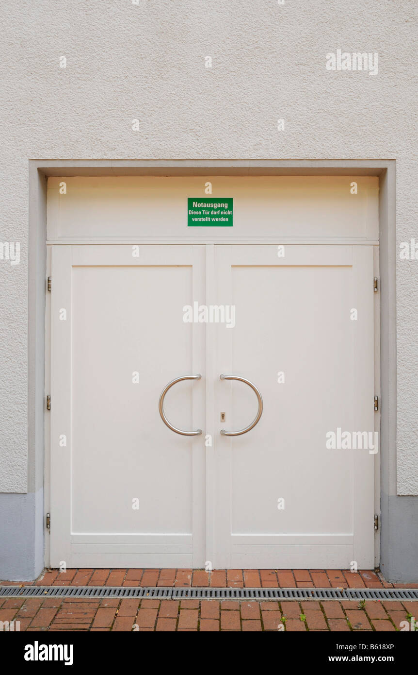 Doublewinged emergency exit door with a singn, this door has to be kept free Stock Photo