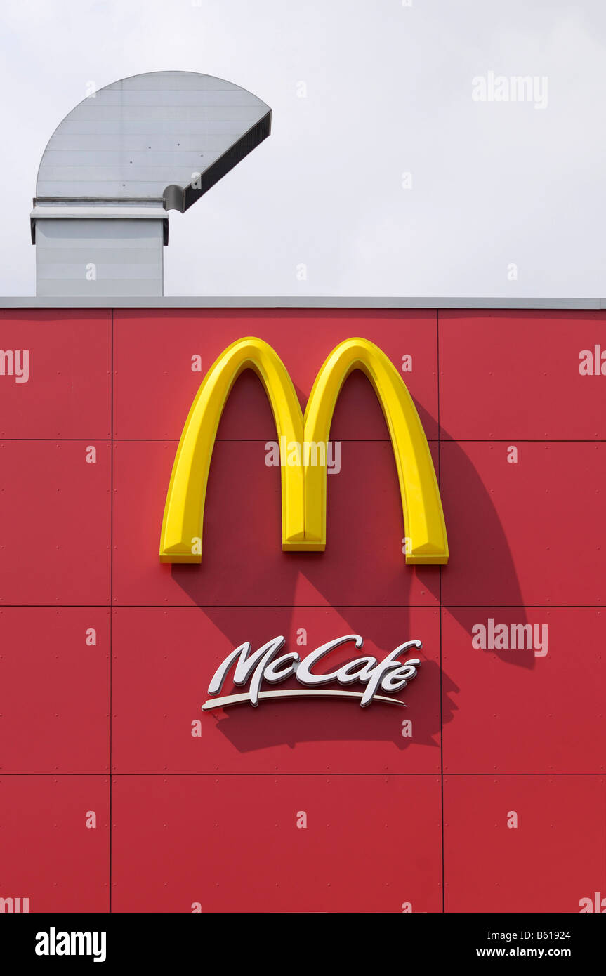 Mc Cafe Logo on a red facade with a kitchen flue Stock Photo