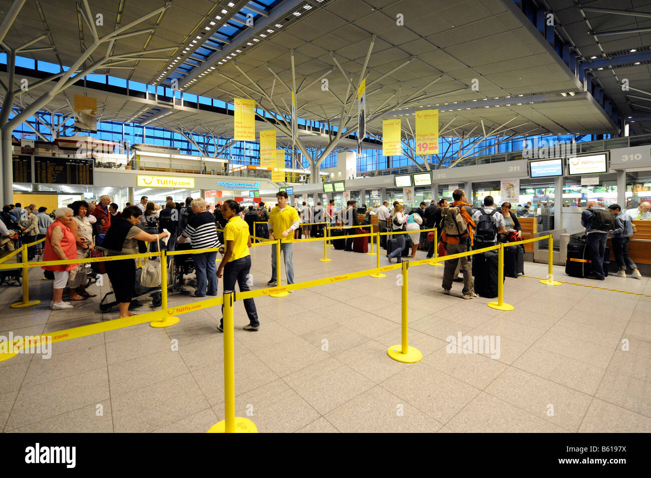Passengers waiting in queues at check-in counters, Stuttgart Airport, Baden-Wuerttemberg Stock Photo