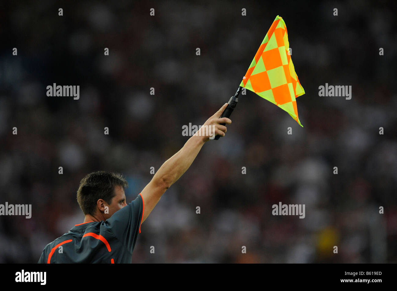 Flag of a linesman indicating match interruption or offside during a football match Stock Photo
