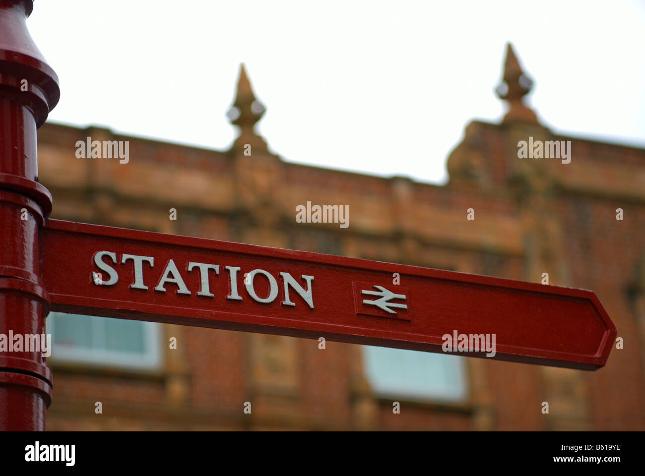 street sign giving directions to the local railway stationin surbiton, surrey, england Stock Photo