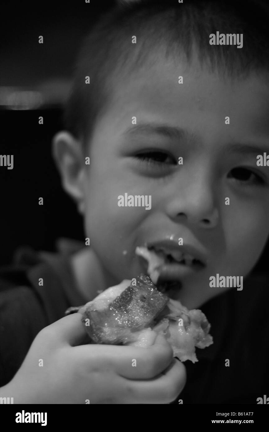 Young Asian Caucasian Male Eating Pizza Black And White Stock Photo