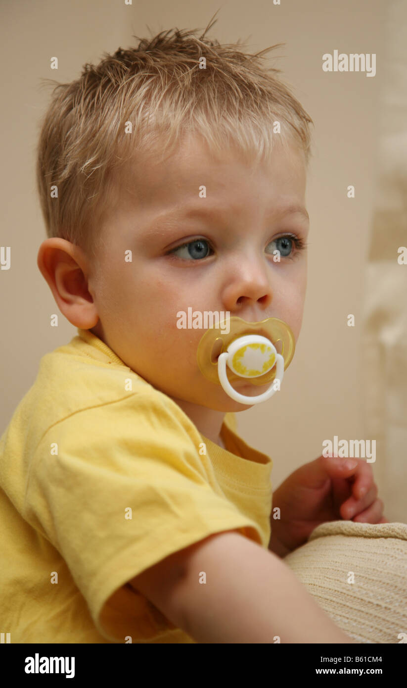 2 year old boy with his pacifiers comforters soothers dummies dummy Stock Photo