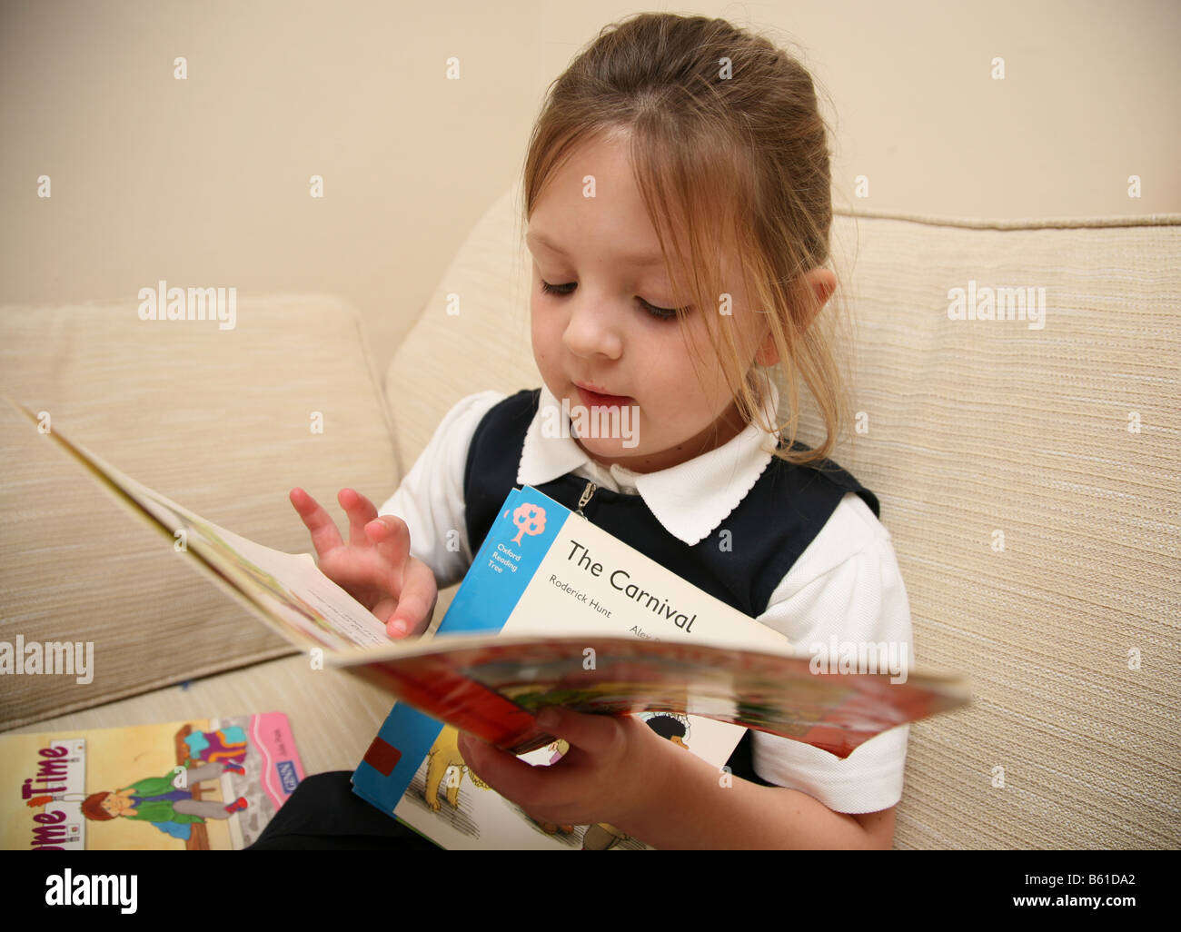 5 year old girl reading her library books Stock Photo - Alamy