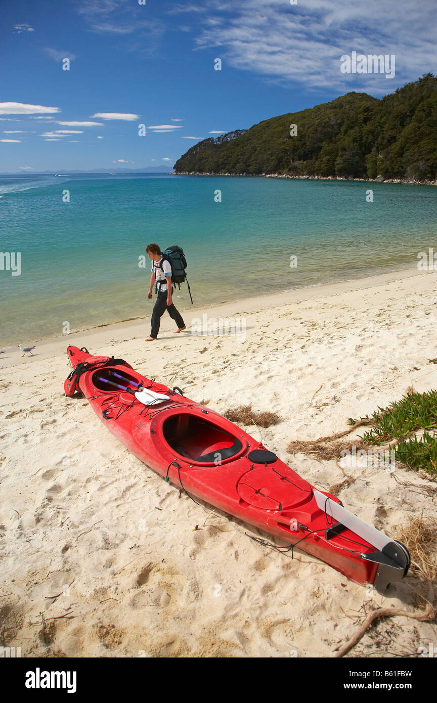 Sea Kayak and Hiker Bark Bay Abel Tasman National Park Nelson Region South Island New Zealand Stock Photo