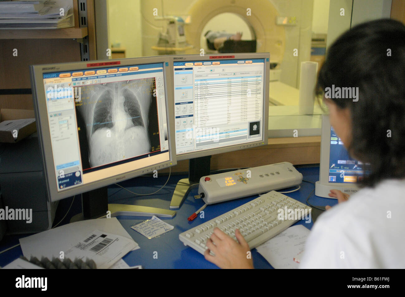 Doctor looking at magnetic resonance image on monitors Stock Photo