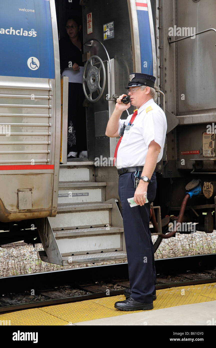 Amtrak railroad conductor communicating with train driver America USA DeLand Train Station Florida America USA Stock Photo