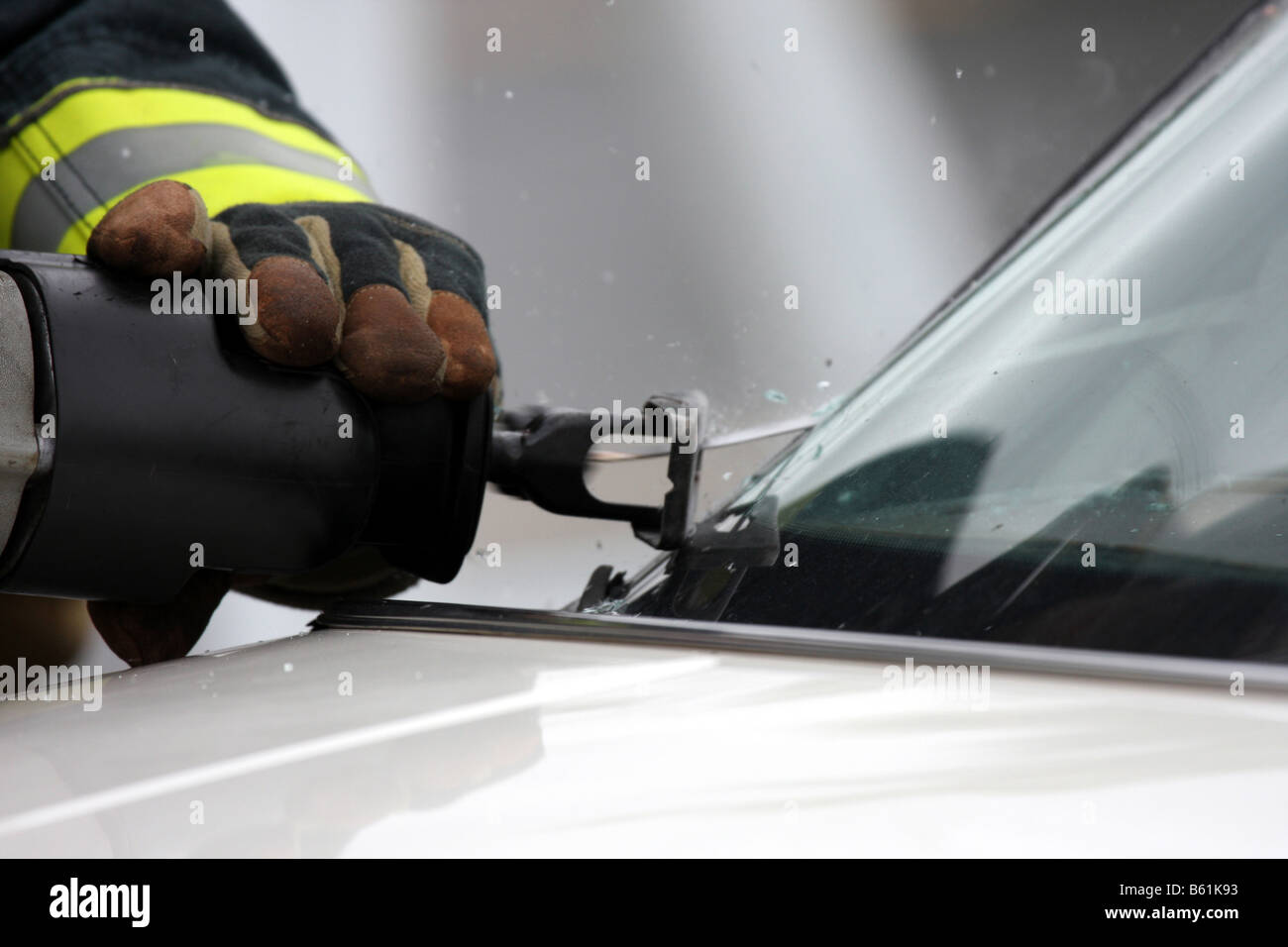 A firefighter cutting the glass windshield of a car during extrication Stock Photo Alamy