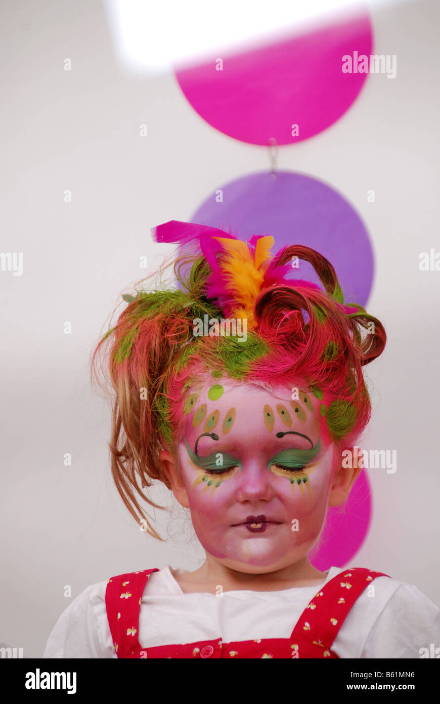 A young girl having her face painted Stock Photo Alamy