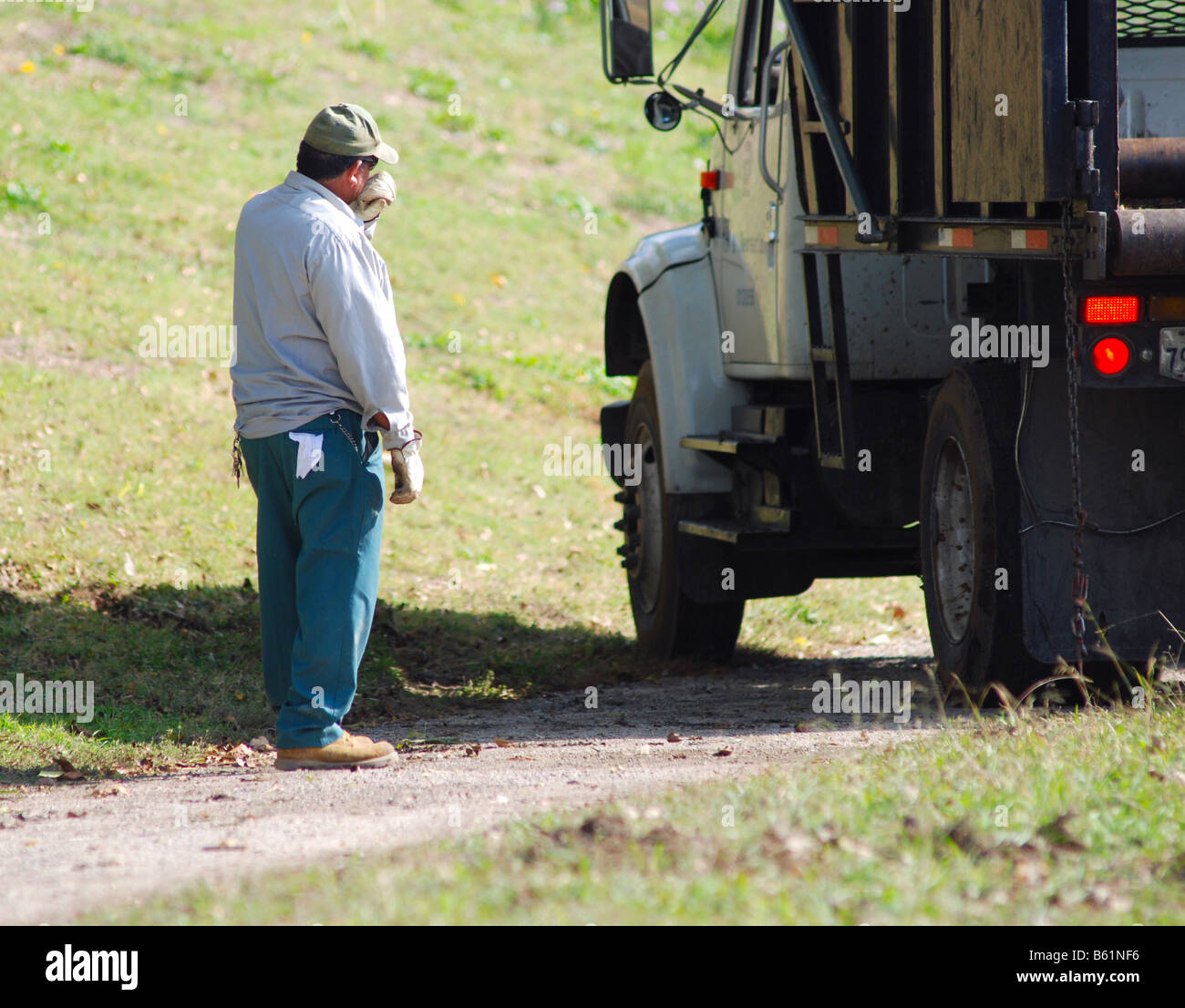 Hispanic (mexican) man standing beside his work truck Stock Photo