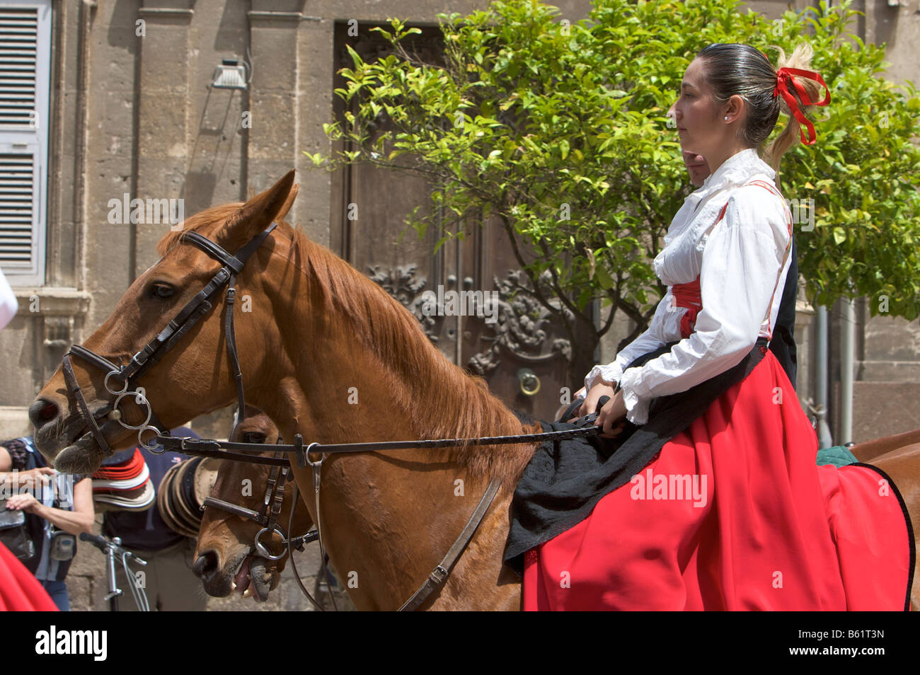 Woman riding a horse while wearing a traditional costume at the Cavalcata Sarda parade in Sassari, Sardinia, Italy, Europe Stock Photo