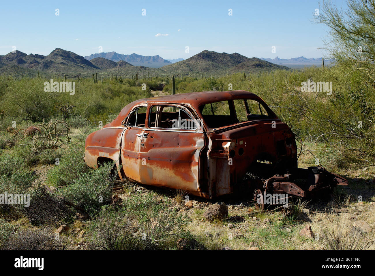 Rusty abandoned car, maybe a 1949 Mercury, in the Sonoran Desert of Arizona Stock Photo