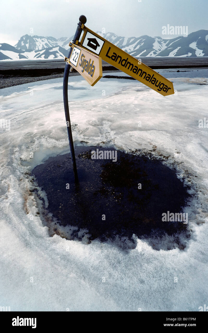 Bent signpost on sheet of ice, impassable road to Landmannalaugar, early summer, South Iceland, Europe Stock Photo