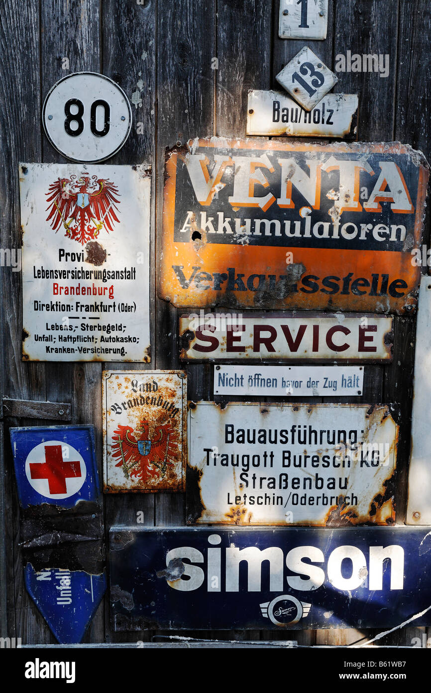 Collection of old tin shields on a wooden door, Letschin municipality, Oderbruch region, Maerkisch-Oderland district, Brandenbu Stock Photo