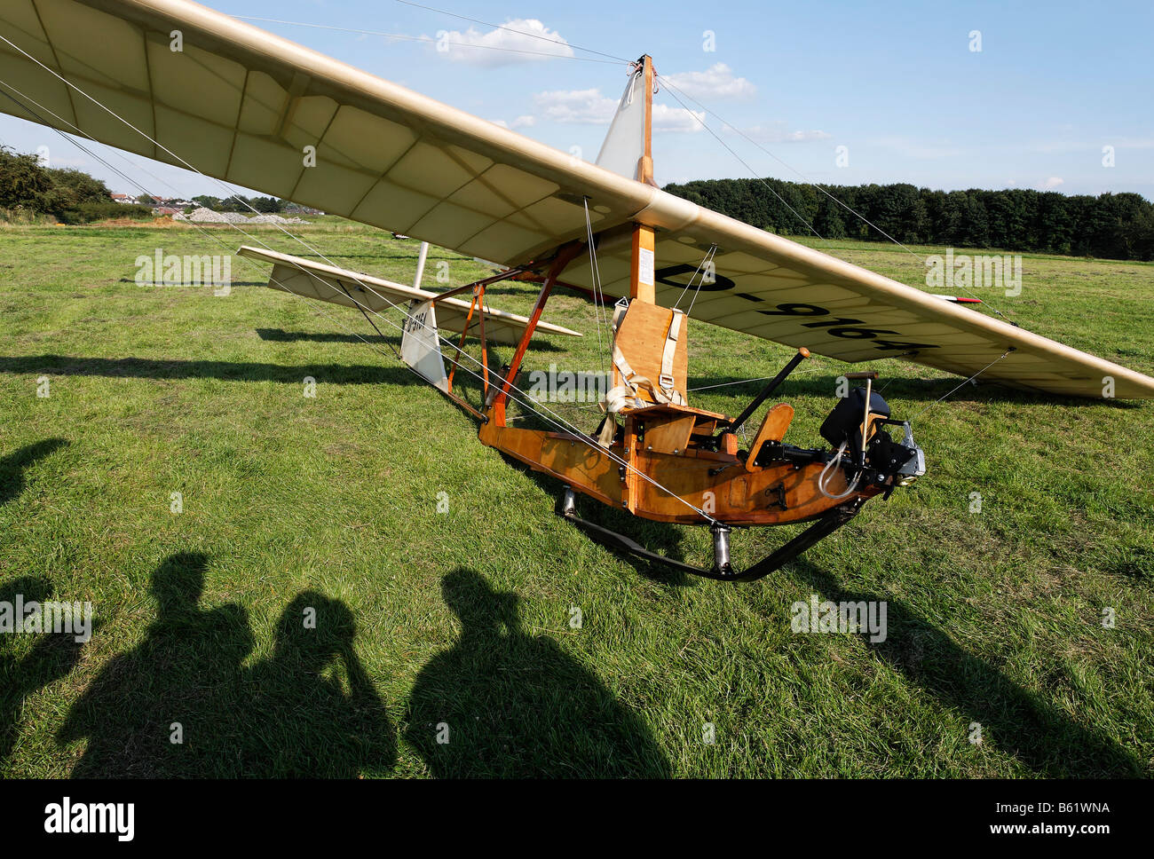 Historic glider SG38 with shadows of spectators on the grass, wooden construction with an open seat, glider to train beginners  Stock Photo