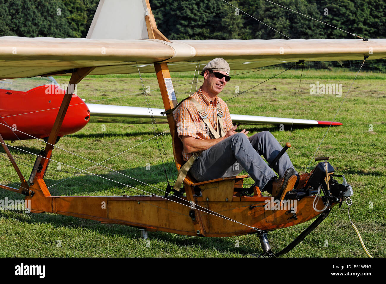 Pilot sitting on the open seat of a historic glider waiting for take-off, glider to train beginners from 1938, wooden construct Stock Photo