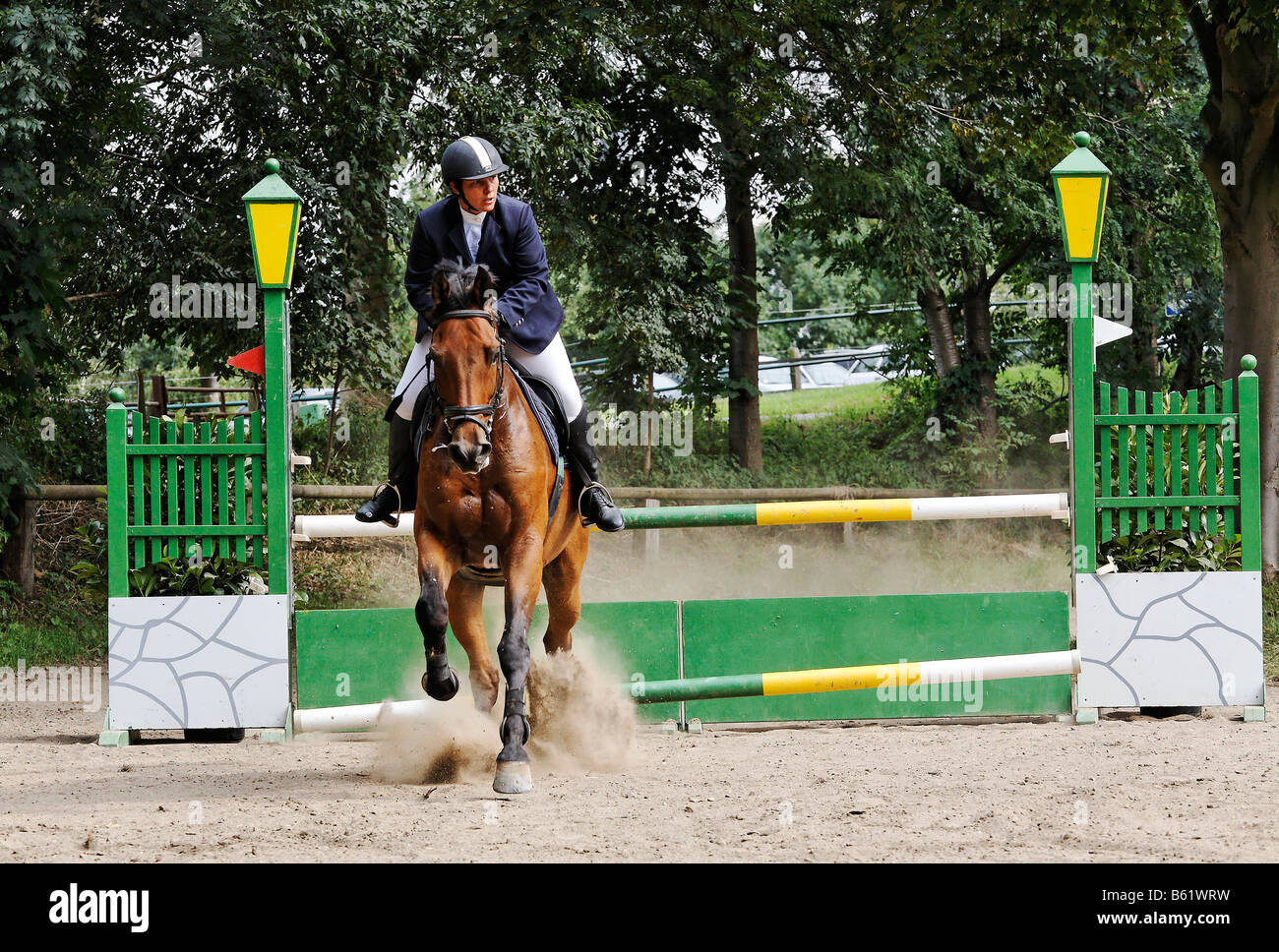 Female show jumper having knocked a pole off a vertical jump and incurring a fault during a show jumping competition at Gross-W Stock Photo