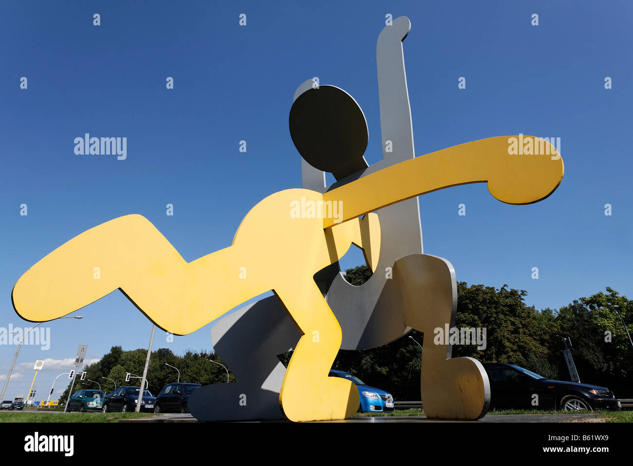 Little man jumping head-first through the stomach of a second man, large metal sculpture by Keith Haring, Ludwig Gallery, Oberh Stock Photo