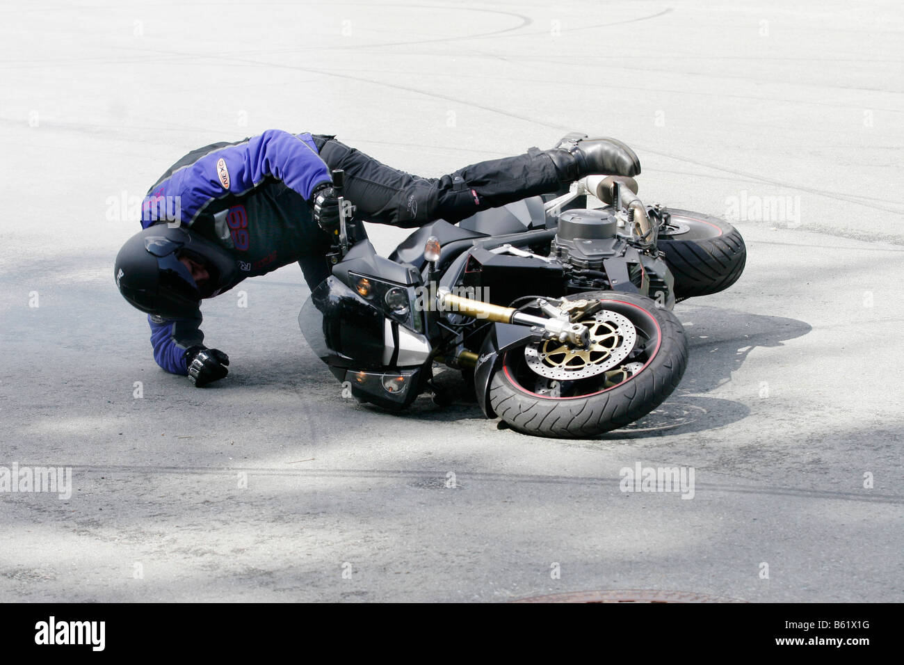 Motorcyclist falling Stock Photo