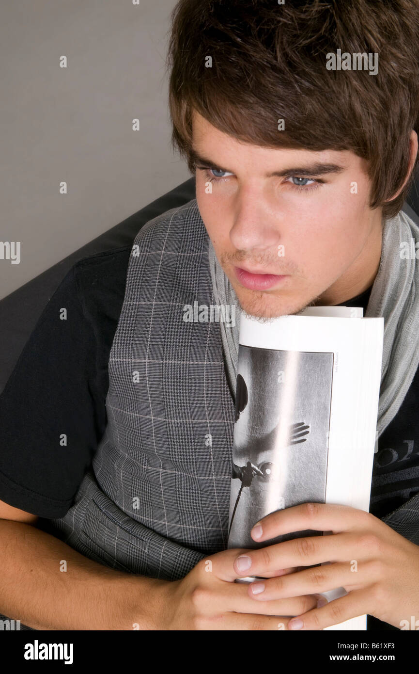 Young man with a newspaper Stock Photo - Alamy