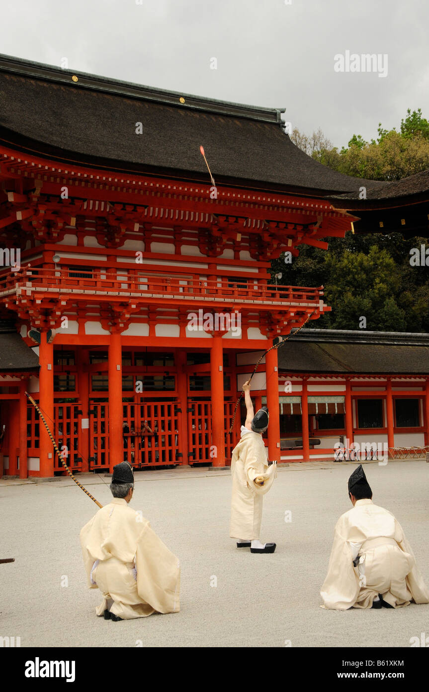 Ritual archers shooting an arrow over the temple gate during a Shinto ...